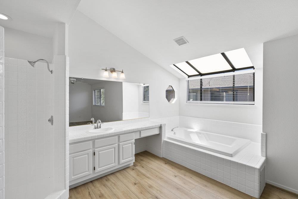 1313 Vía Tornasol Aptos, CA 95003 - Photo 26 of 38 a spacious bathroom with a tub sink shower and mirror