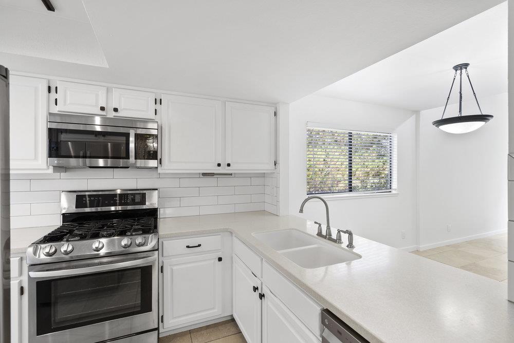 1313 Vía Tornasol Aptos, CA 95003 - Photo 8 of 38 a kitchen with stainless steel appliances a stove sink and microwave