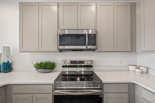 a kitchen with stainless steel appliances a stove a microwave and cabinets