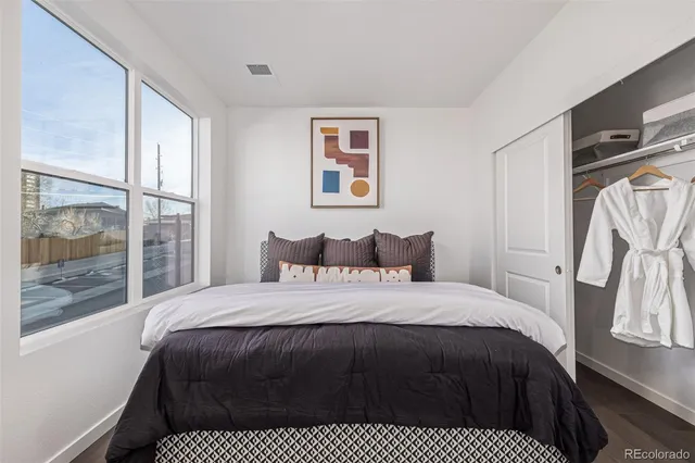 a bedroom with a large bed and a window