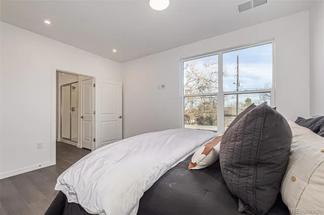 a bed sitting in a bedroom next to a window