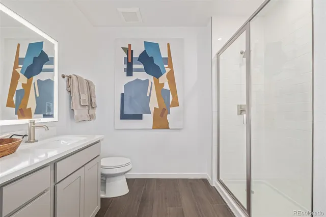 a bathroom with a toilet a sink and a mirror