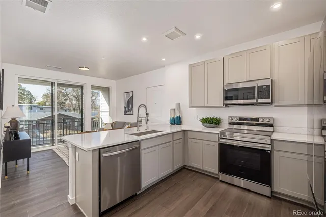 a kitchen with sink a microwave and stove