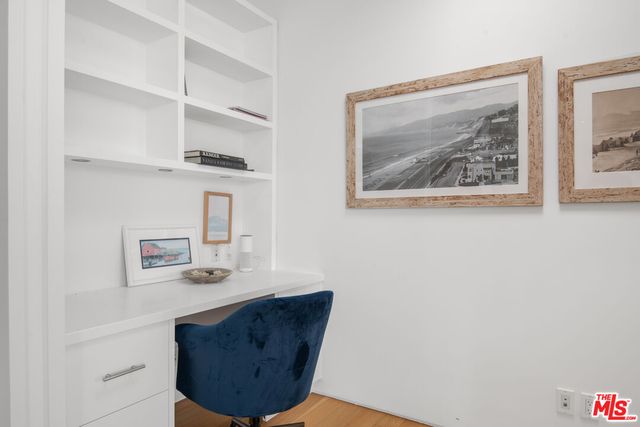 a bedroom with a bed a table and chair