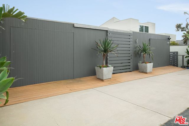 a view of potted plants with wooden fence