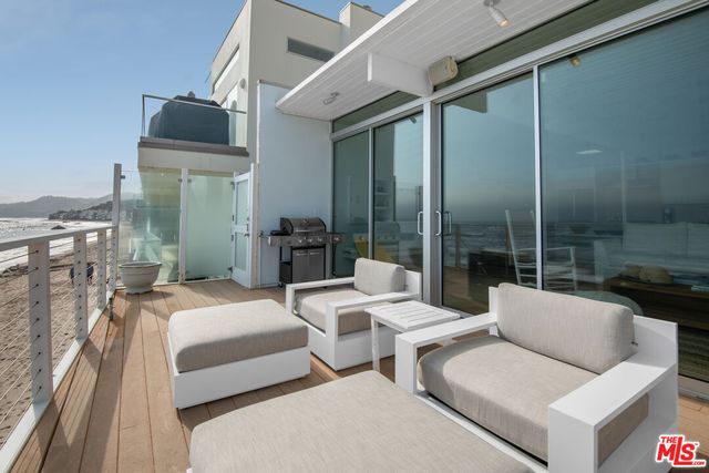 a view of living room with furniture and floor to ceiling window
