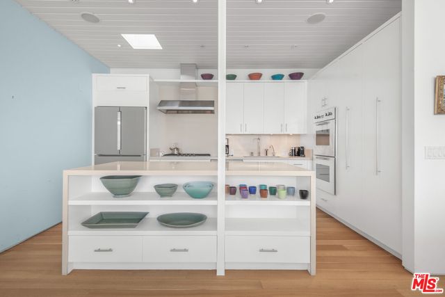 a kitchen with stainless steel appliances granite countertop a sink and stove top oven