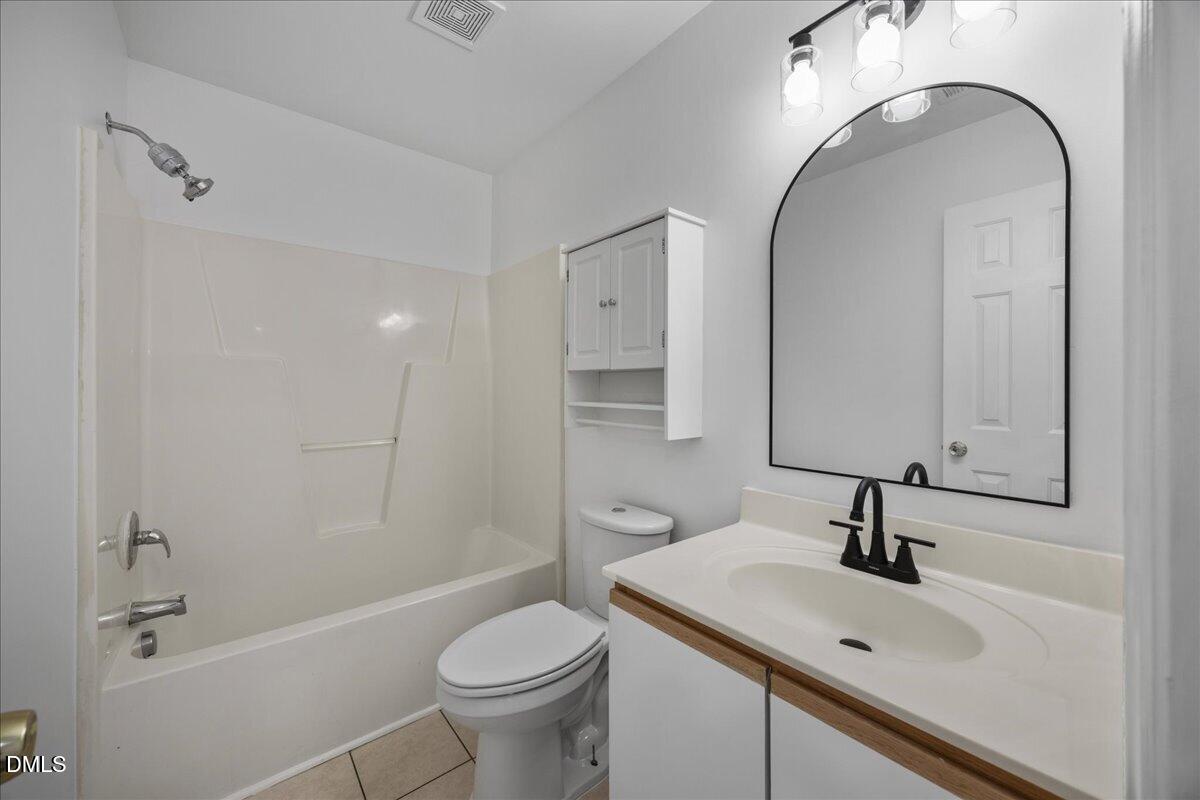 3831 Pin Oak Road Raleigh, NC 27604 - Photo 15 of 24 a bathroom with a sink toilet and shower