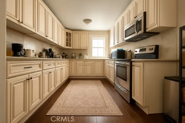 a kitchen with stainless steel appliances granite countertop a stove a sink and a refrigerator