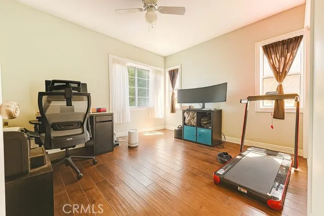 a living room with furniture flat screen tv and wooden floor