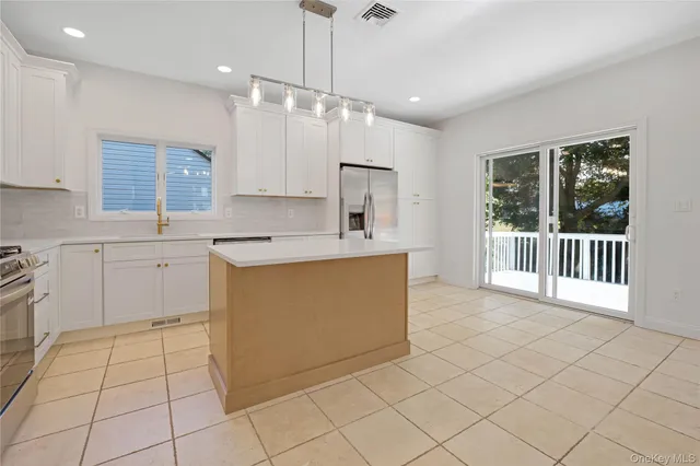 a view of an empty room with a fireplace and a window