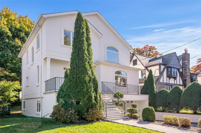 a front view of a house with garden
