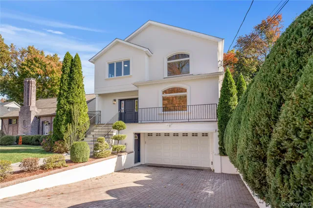 a view of a house with a yard and potted plants