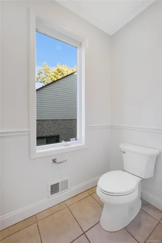 a white toilet sitting next to a bathroom sink