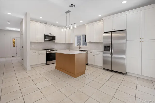 a kitchen with stainless steel appliances granite countertop a refrigerator sink and cabinets