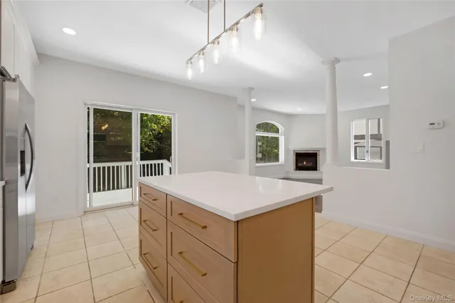 a kitchen that has a sink a stove and a refrigerator