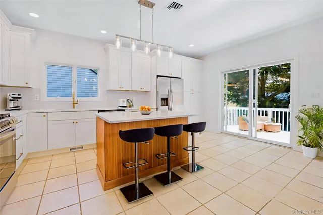 a kitchen with a sink window and cabinets