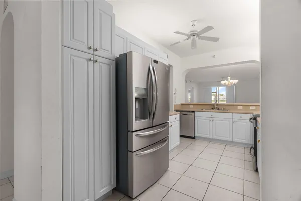 a utility room with cabinets washer and dryer