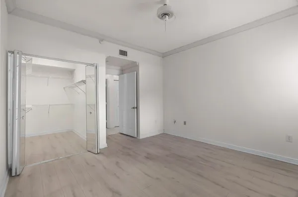 a bedroom with bed painting and window