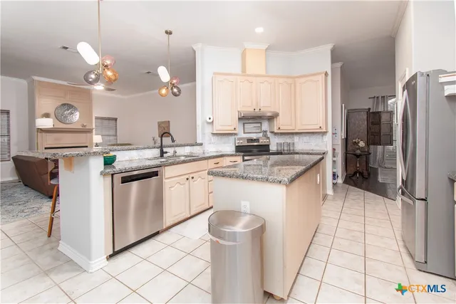 a kitchen with a sink stove and cabinets