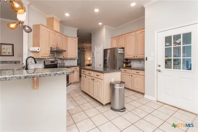 a kitchen with appliances cabinets and a sink