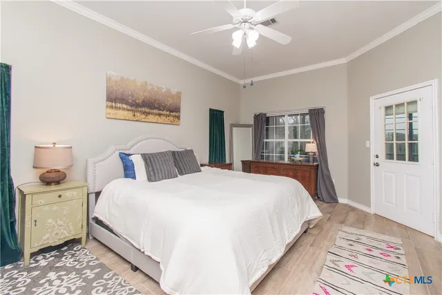 a bedroom with bed and wooden floor