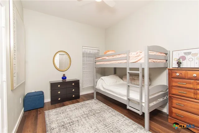 a bed room with a bed and a mirror