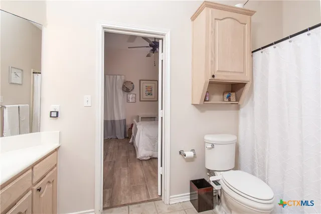 a bathroom with a toilet a sink and a shower
