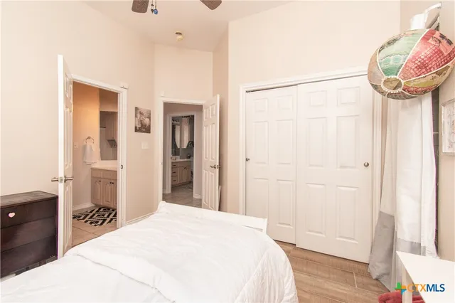 a bedroom with a bed and a mirror