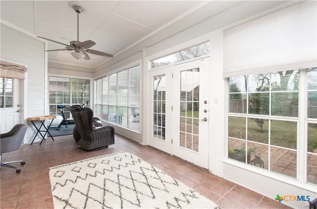 a living room with furniture windows and wooden floor