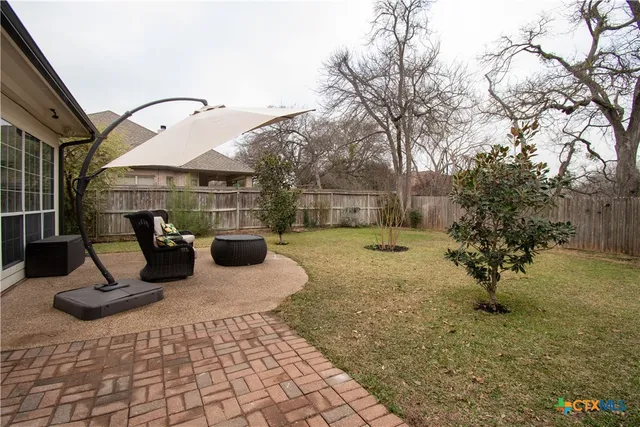 a view of a patio with table and chairs and potted plants