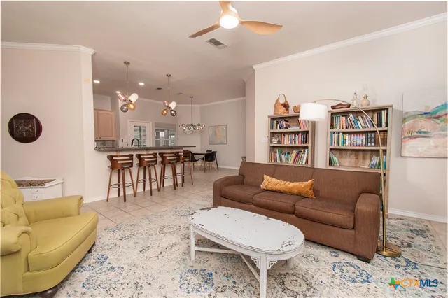 a living room with furniture and a view of kitchen