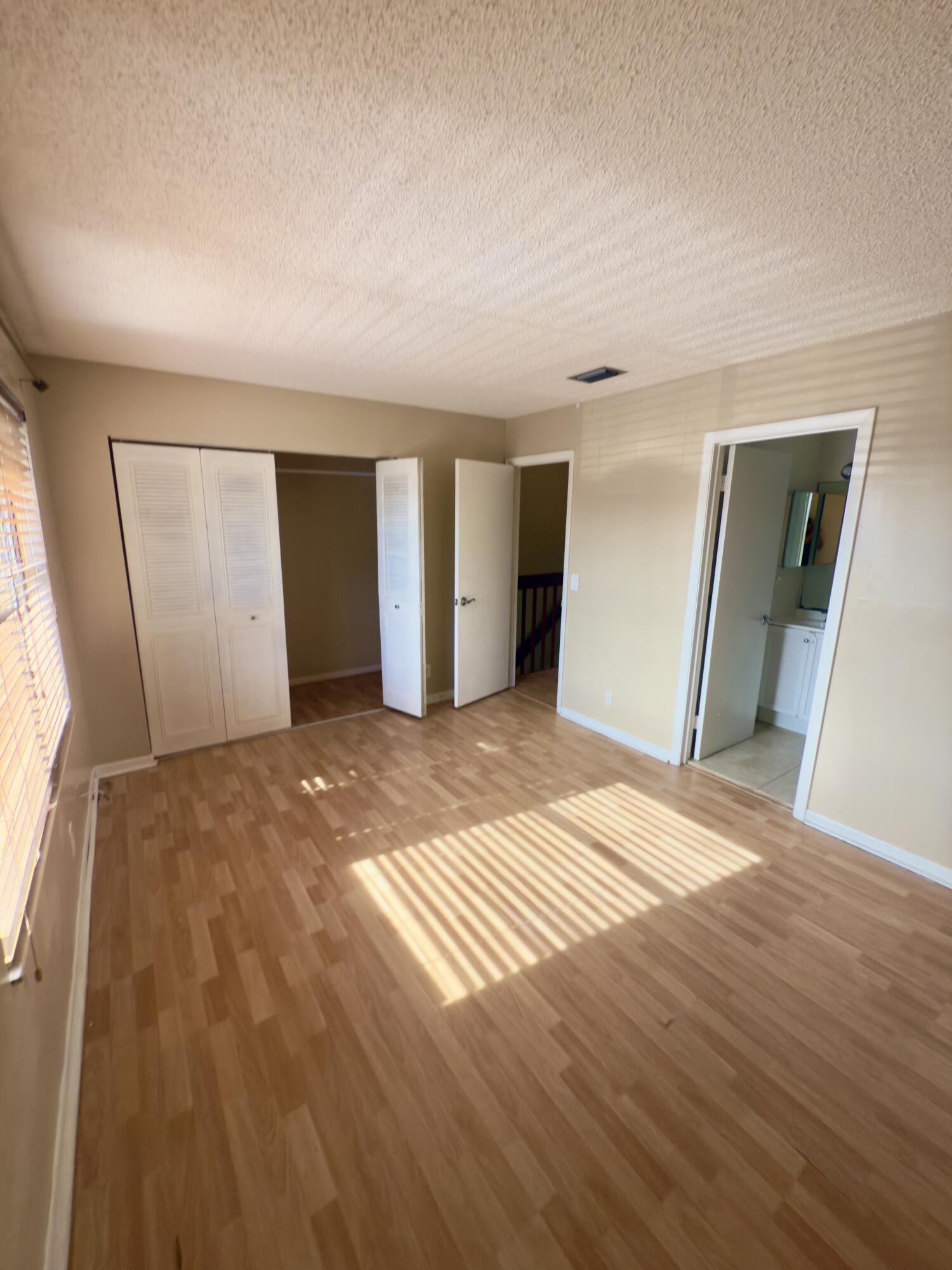 799 Hill Drive, Unit F West Palm Beach, FL 33415 - Photo 12 of 14 a view of a livingroom with wooden floor and kitchen