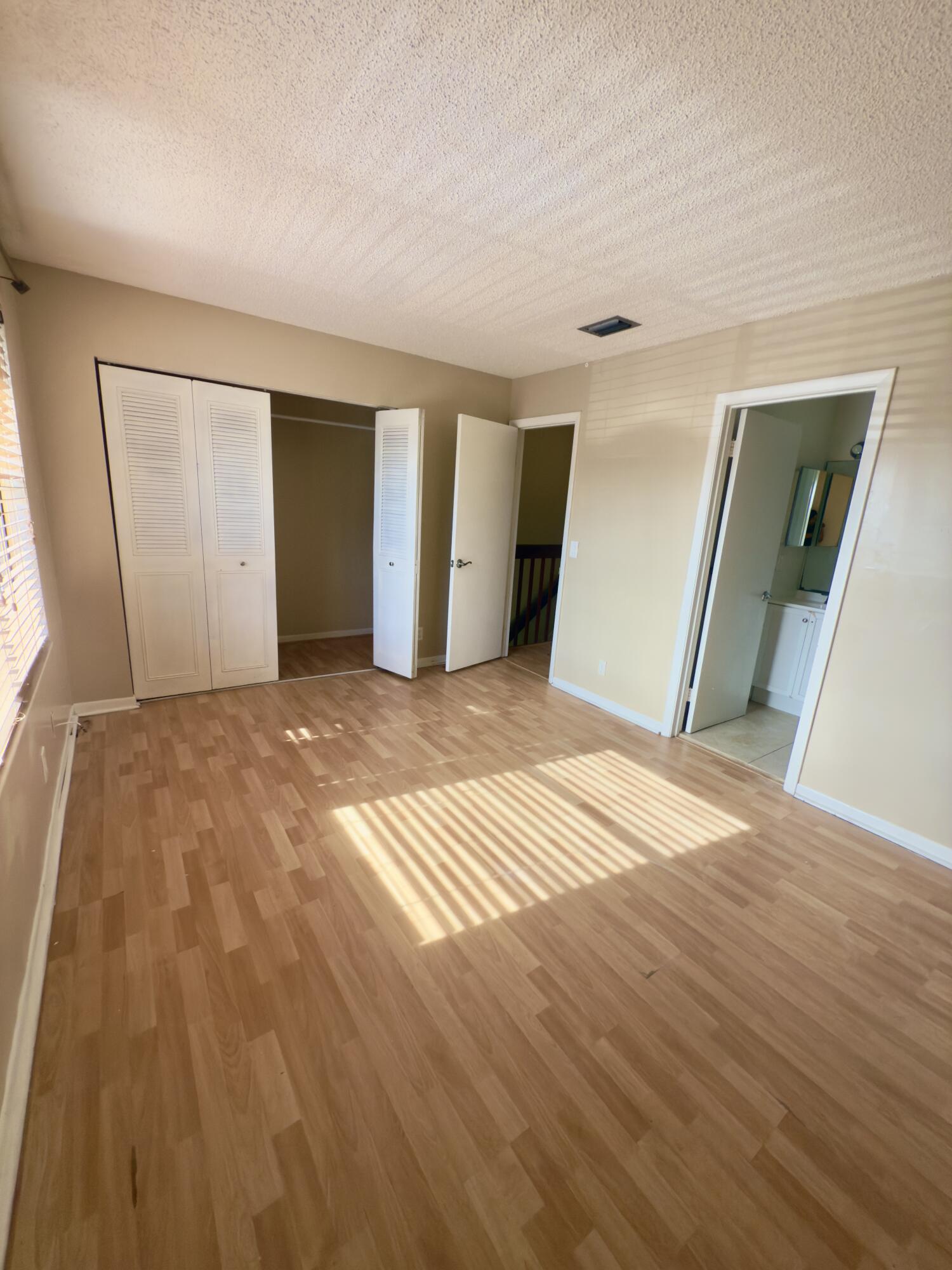 799 Hill Drive, Unit F West Palm Beach, FL 33415 - Photo 7 of 14 a view of a big room with wooden floor and windows
