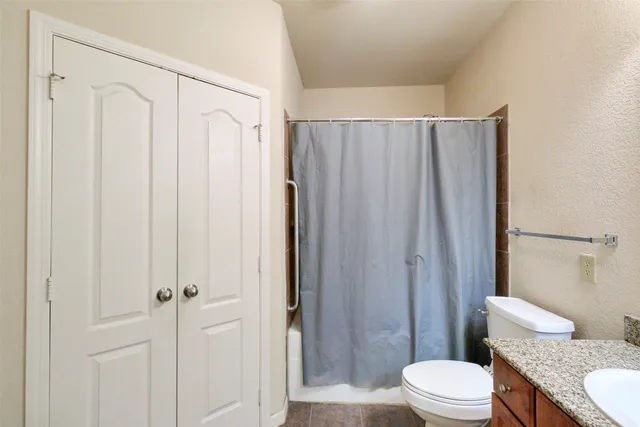 a bathroom with a toilet a sink and a shower