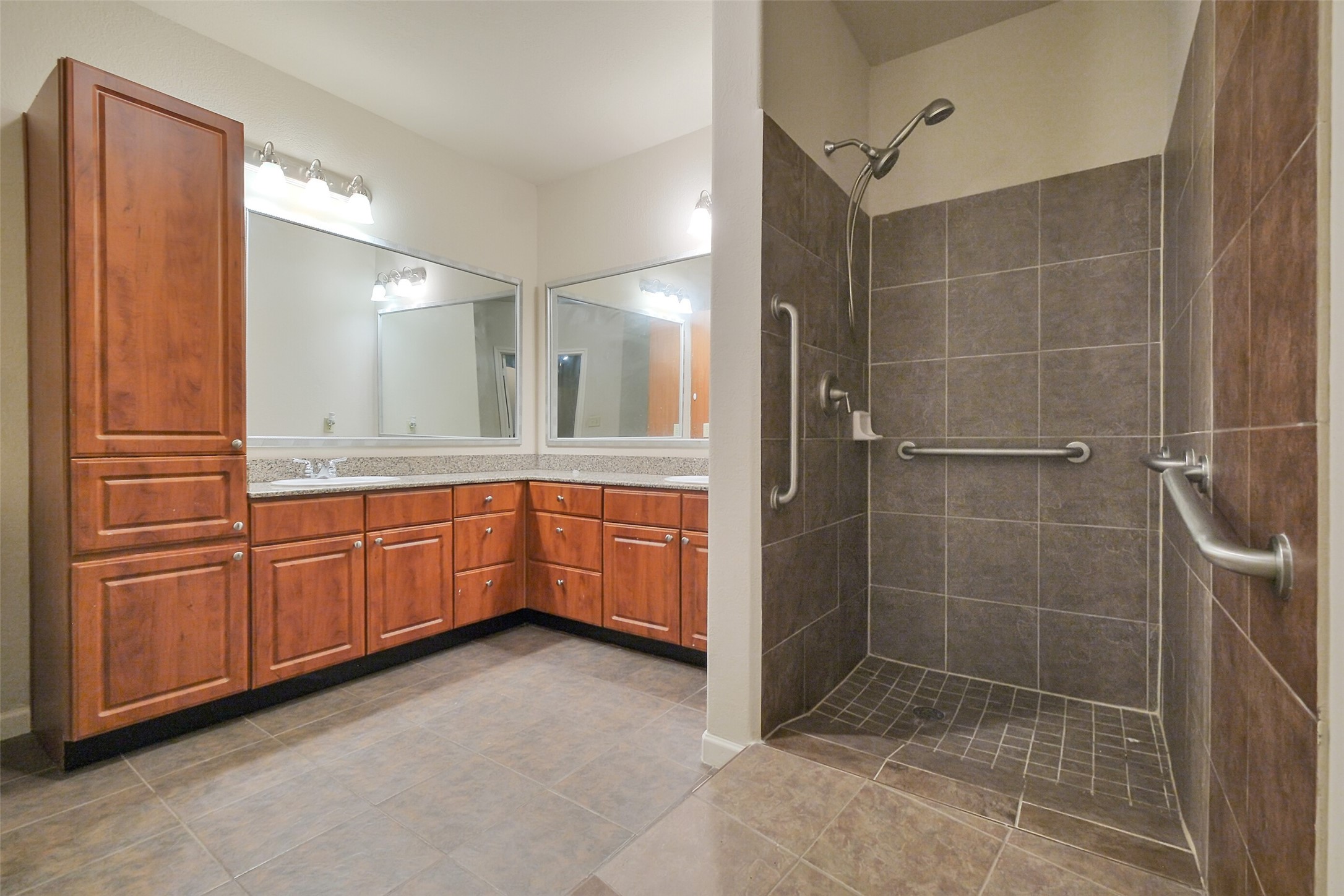1711 Old Spanish Trail, Unit 128 Houston, TX 77054 - Photo 6 of 26 a bathroom with a granite countertop sink a mirror and a shower