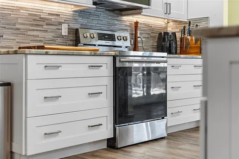 a stove top oven sitting inside of a kitchen