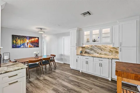 a living room with granite countertop furniture and wooden floor