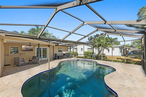 a swimming pool with outdoor seating and yard