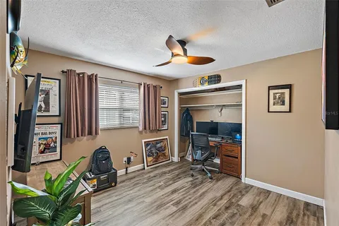 a view of a livingroom with workspace and a window