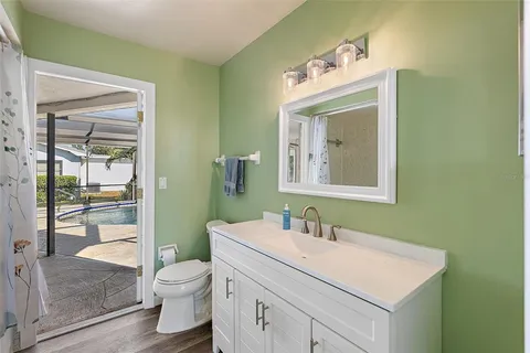 a bathroom with a sink vanity mirror and toilet