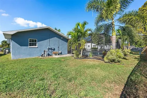 a view of a backyard with table and chairs and potted plants