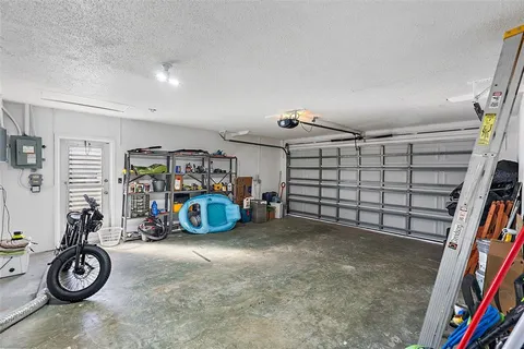 an aerial view of residential houses with outdoor space and lake view