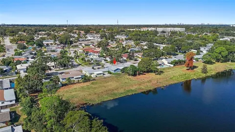 a view of a house with a yard with palm trees