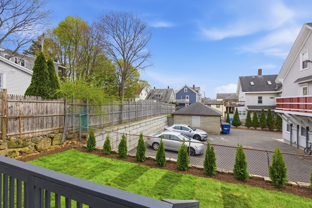 9 Robbins Street Waltham, MA 02453 - Photo 35 of 42 a view of a house with a backyard and a patio