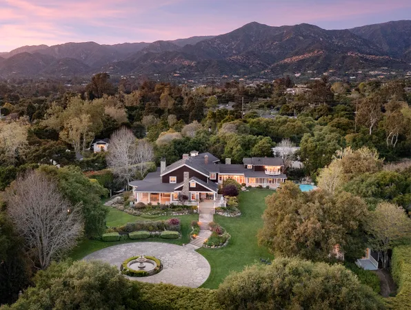 an aerial view of residential house with outdoor space and mountains