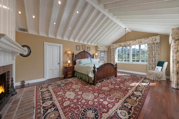 a spacious bedroom with a large bed and a window