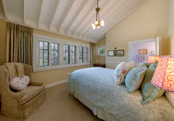 a bedroom with a bed couch and window