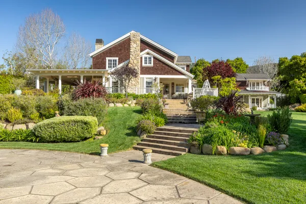 a front view of a house with a garden