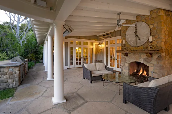 a building outdoor space with patio furniture and potted plants